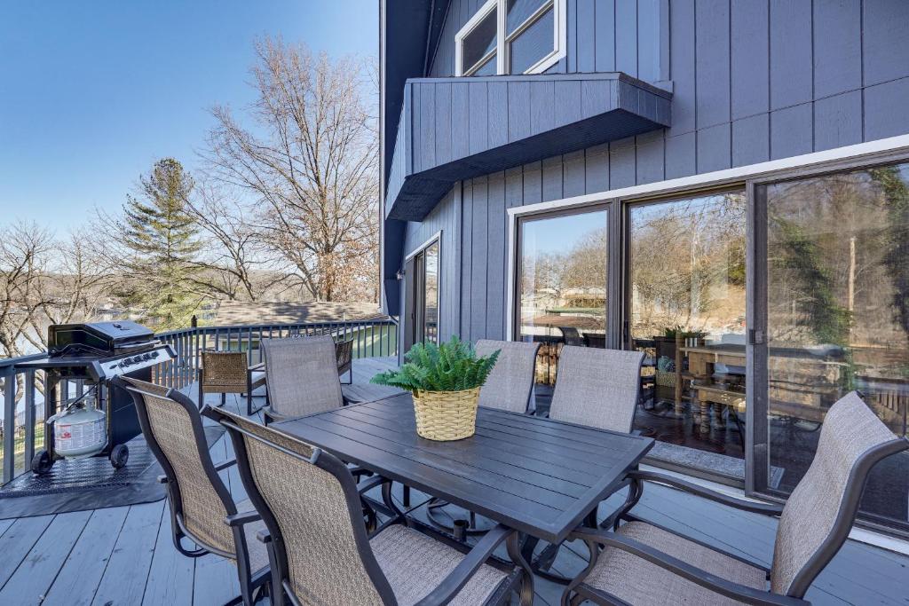 a patio with a table and chairs on a deck at Lakefront Home with Dock and Decks in Gravois Mills! in Gravois Mills