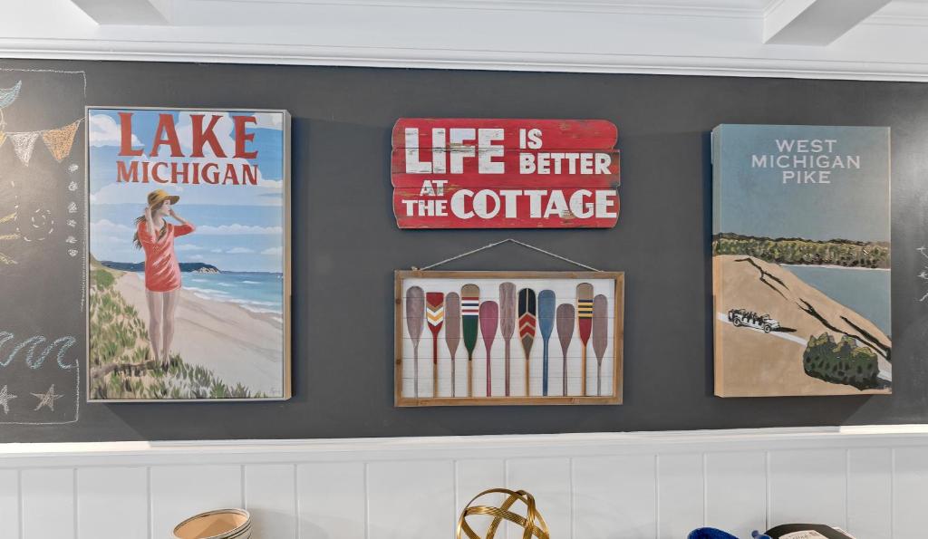 a wall with posters on it with surfboards on it at Hillside Cottage- Great Vacation Rental with Private Pool in Muskegon