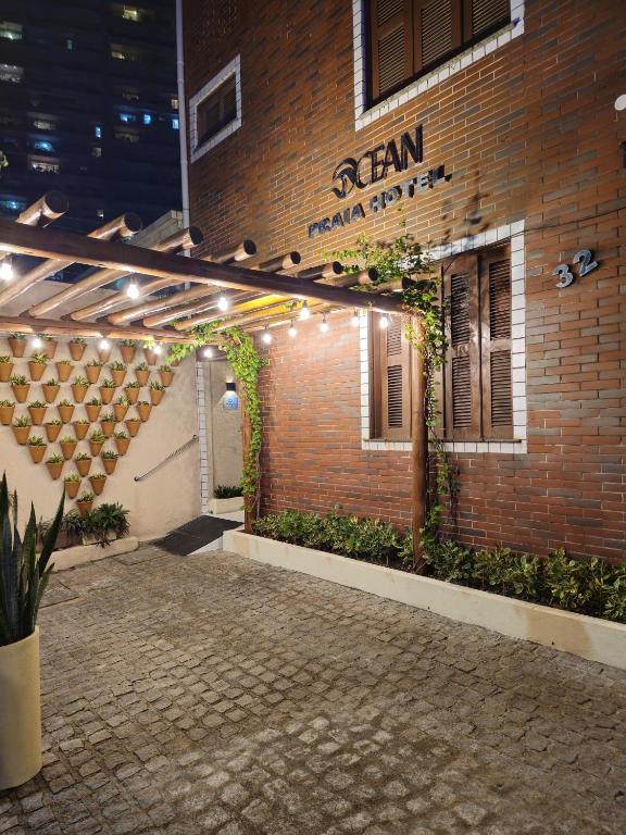 a brick building with plants on the side of it at Ocean Praia Hotel in Fortaleza