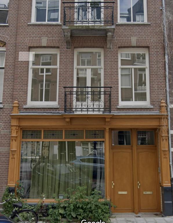 a building with glass doors and a balcony at Boutique Amsterdam in Amsterdam