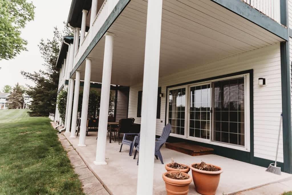 a porch of a house with chairs and potted plants at Picturesque Condo perfect for Golf, Families, Pools and Lake vacation in Bellaire