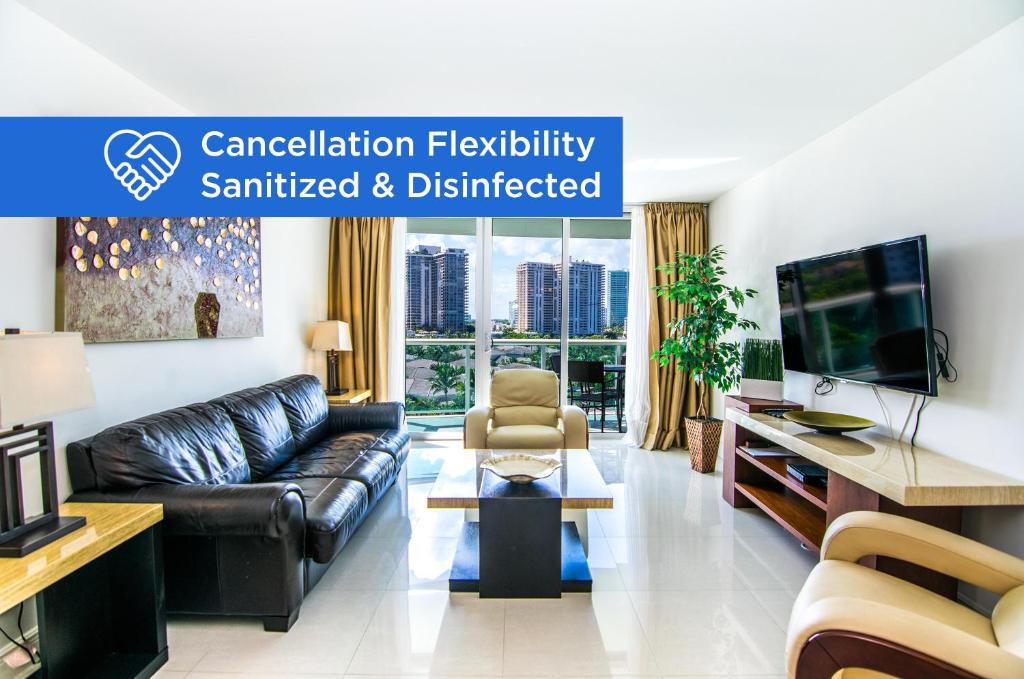a living room with a couch and a tv at Ocean Reserve 818 in Miami Beach