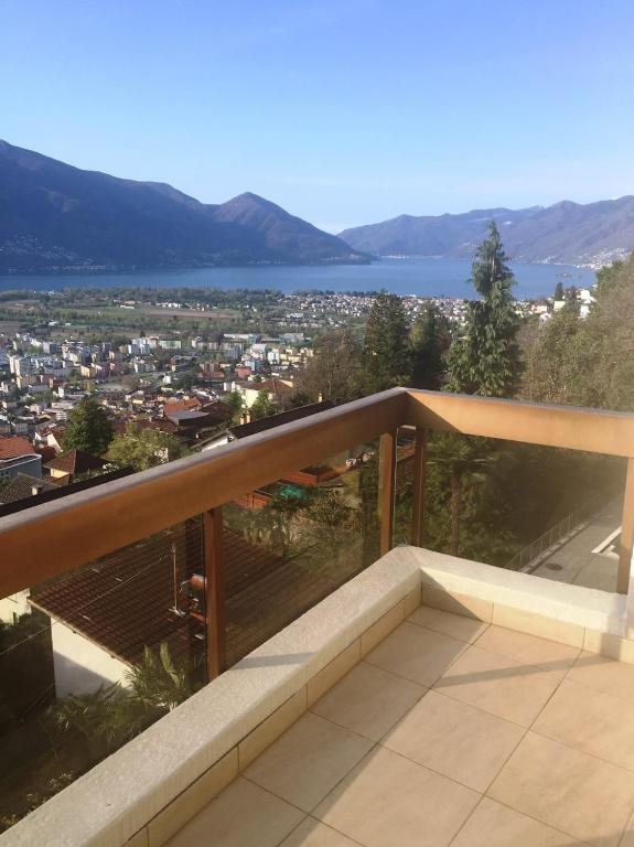 a balcony with a view of a city at Ferienwohnung C11 in Orselina