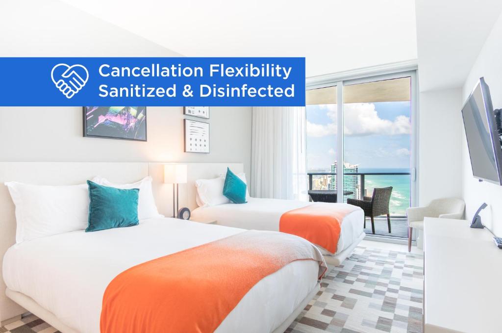 two beds in a hotel room with the words cancellation flexibility sanctated and distracted at Lyfe Beach Resort 3804 in Beverley Beach