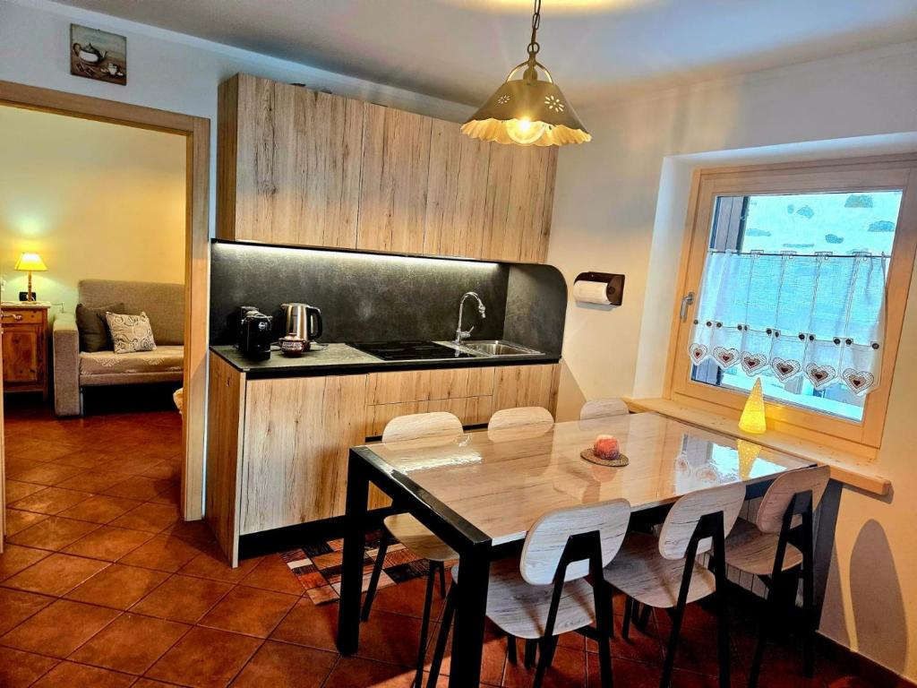 a kitchen with a table and a dining room at Sunrise Livigno in Livigno