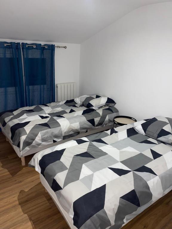 deux lits côte à côte dans une pièce dans l'établissement Joli maison refait à neuf #2, à Vierzon