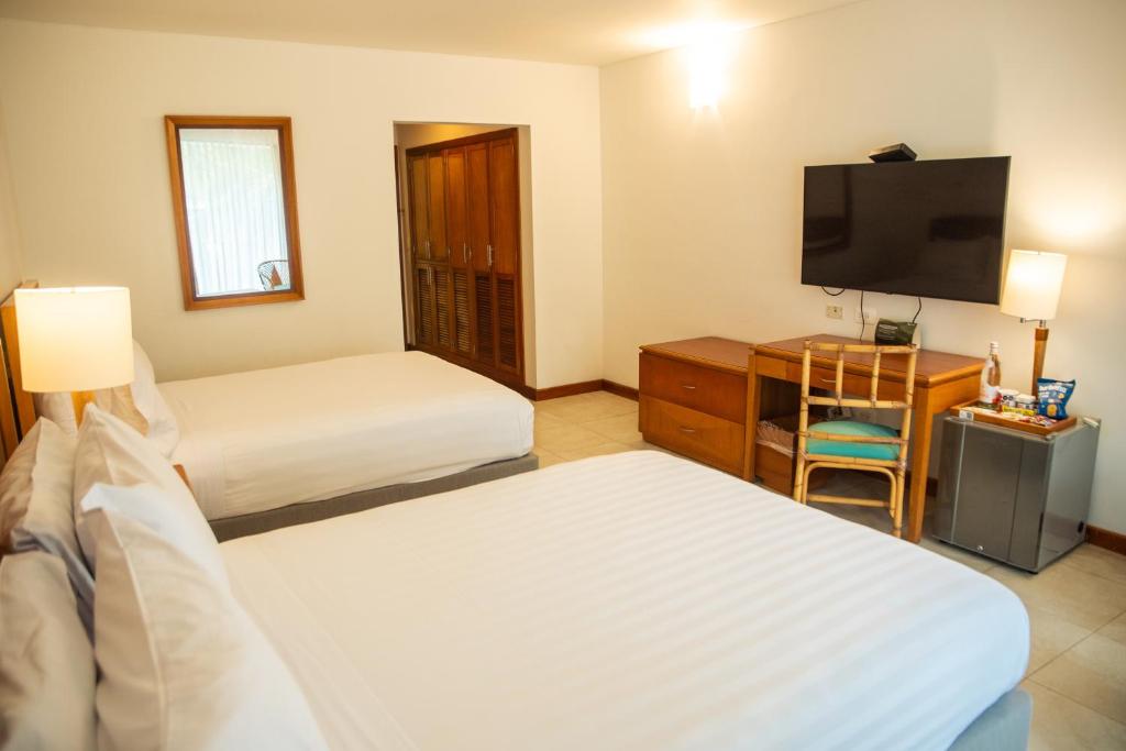 Postel nebo postele na pokoji v ubytování Estelar Santamar Hotel & Centro De Convenciones