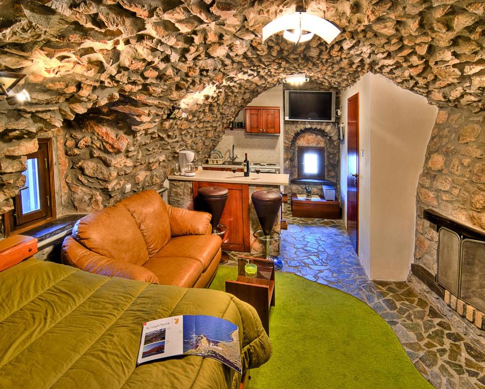 a living room with a stone wall at Avgonima All Seasons Hotel in Avgonyma