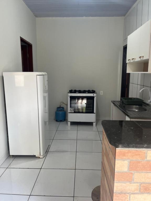 a kitchen with a refrigerator and a stove at Meu cantinho in Santarém