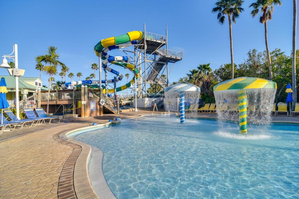 a water slide in a pool at a resort at Waterfront Condo with Water Park, Walk to the Beach! in Clearwater Beach