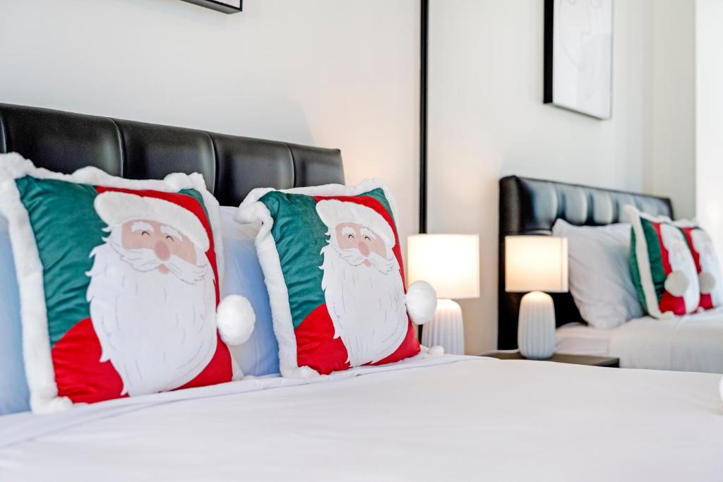 a bedroom with santa pillows on a bed at Modern 3B2B apt with superb stadium view at sydney olympic park in Sydney