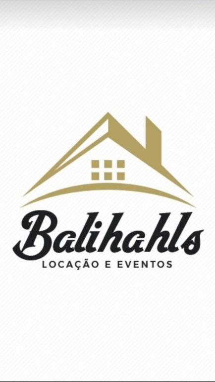 a logo for a real estate company with a house at Balihahls in Prudentópolis