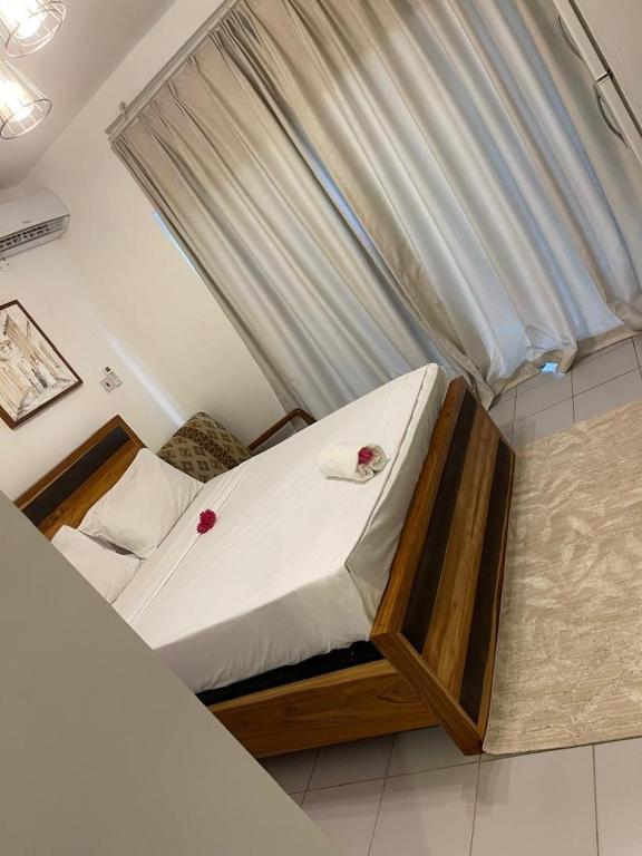 a bed with a canopy in a room at Mama's Studio Apartment in Zanzibar City