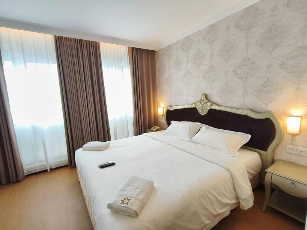 Postel nebo postele na pokoji v ubytování RC Hotel Melaka