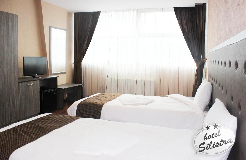 Postel nebo postele na pokoji v ubytování Family Hotel Silistra