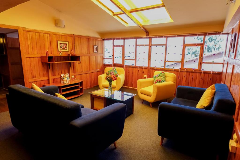 a living room with couches and chairs and a table at BEAUTIFUL, SPACIOUS & COZY HOUSE LOCATED IN THE HEART OF CUSCO in Cusco