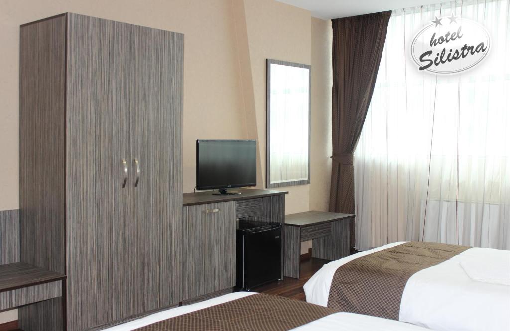 Postel nebo postele na pokoji v ubytování Family Hotel Silistra