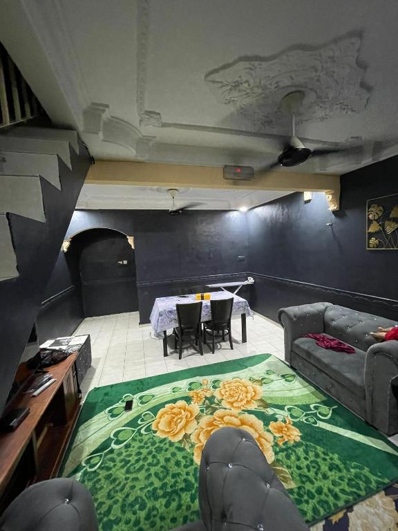a living room with a couch and a table at Lylinz Dy Cermai in Pasir Gudang