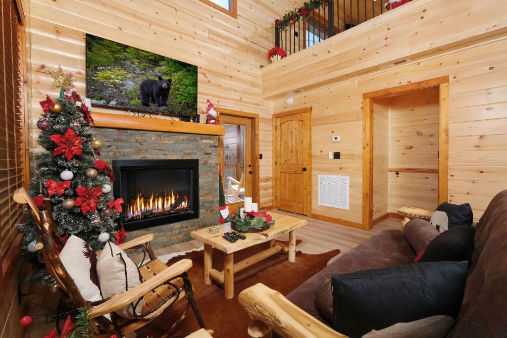 a living room with a fireplace and a christmas tree at Chestnut Tower in Gatlinburg