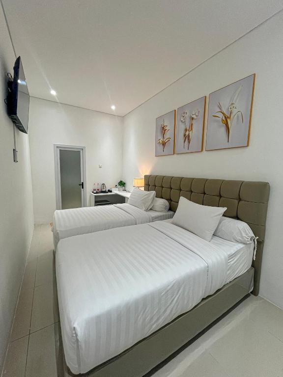 Postel nebo postele na pokoji v ubytování Graha Socio Hotel Nusa Dua Bali