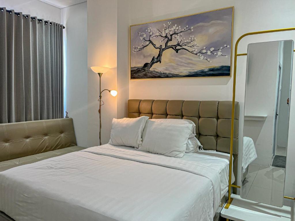 Postel nebo postele na pokoji v ubytování Graha Socio Hotel Nusa Dua Bali