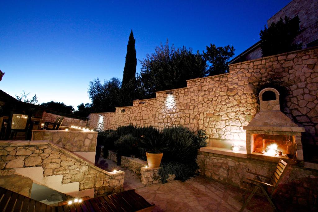 a stone building with a brick wall with a fireplace at Villa More 3 Apartments A-10, A-11 and A-12 , 4-4-6 Beds in Bobovišća