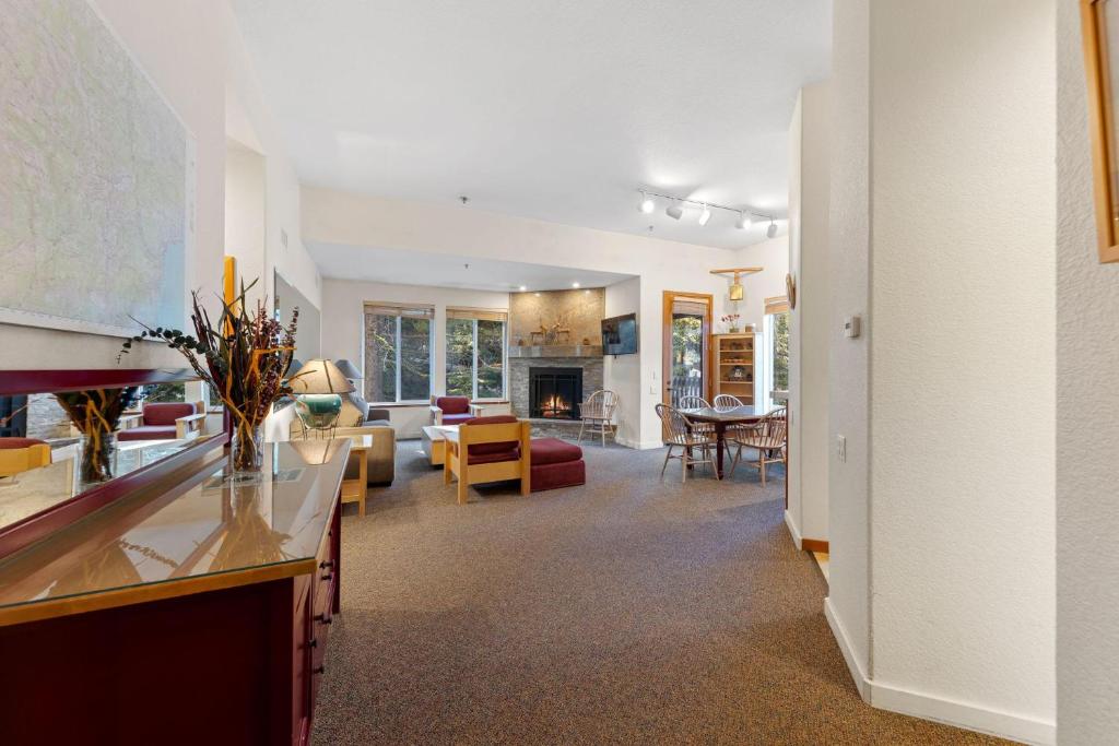a living room with a kitchen and a dining room at Palisades Tahoe Lodge Rentals Two Bedroom #521 in Olympic Valley