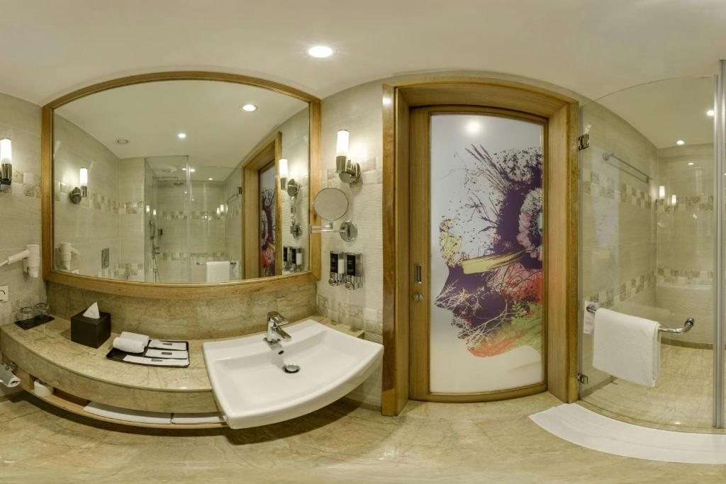a bathroom with a sink and a large mirror at Fairfield by Marriott Lucknow in Lucknow