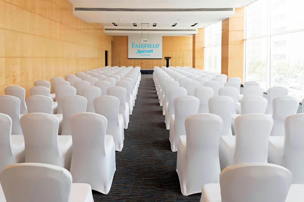 an empty room with white chairs and a sign at Fairfield by Marriott Lucknow in Lucknow