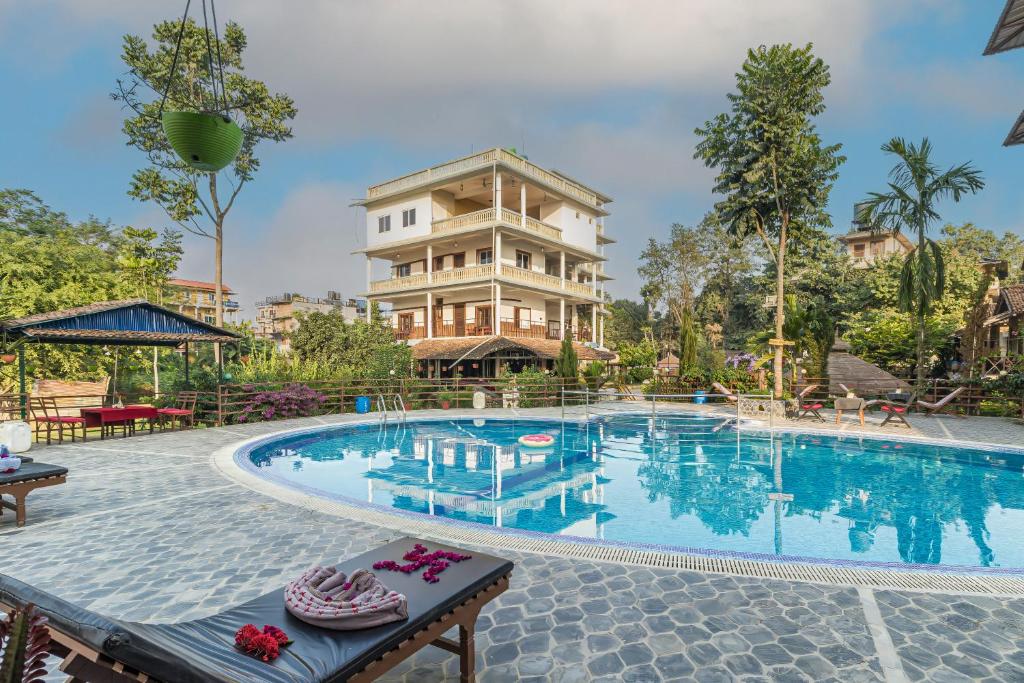 a large swimming pool in front of a building at Hotel Riverside with Swimming pool in Sauraha