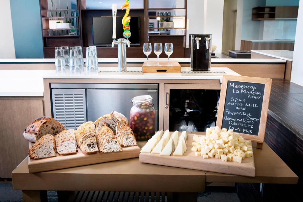 a table with different types of bread and wine glasses at Element Miami International Airport in Miami