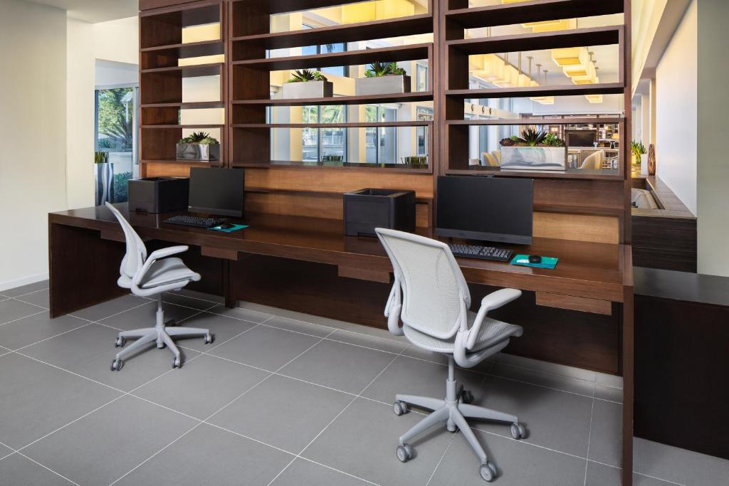 an office with two chairs and a desk with two monitors at Element Miami International Airport in Miami