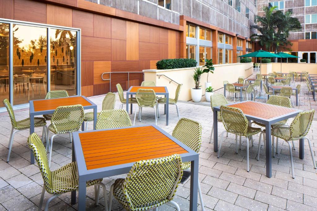 a patio with tables and chairs and a building at Element Miami International Airport in Miami