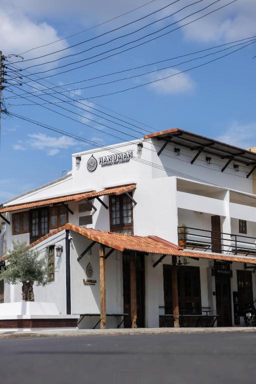 a white building on the side of a street at Hanuman Boutique Stay &Eatery in Hat Yai