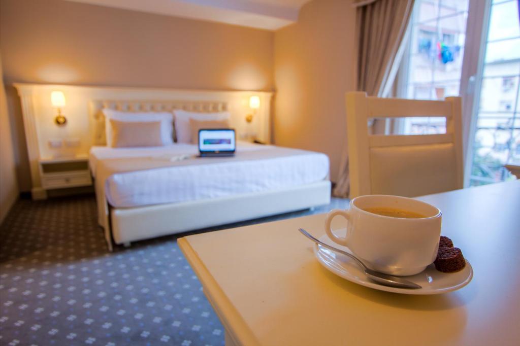 a hotel room with a cup of coffee on a table at Lot Boutique Hotel by Hotels and Preference in Tirana