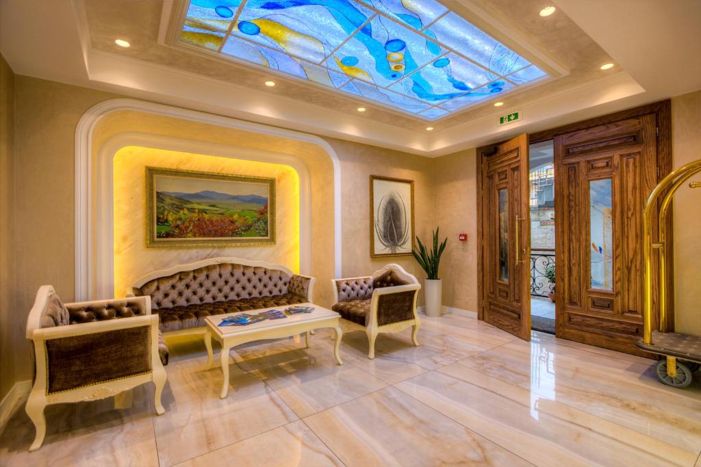 a living room with a couch and a glass ceiling at Lot Boutique Hotel by Hotels and Preference in Tirana