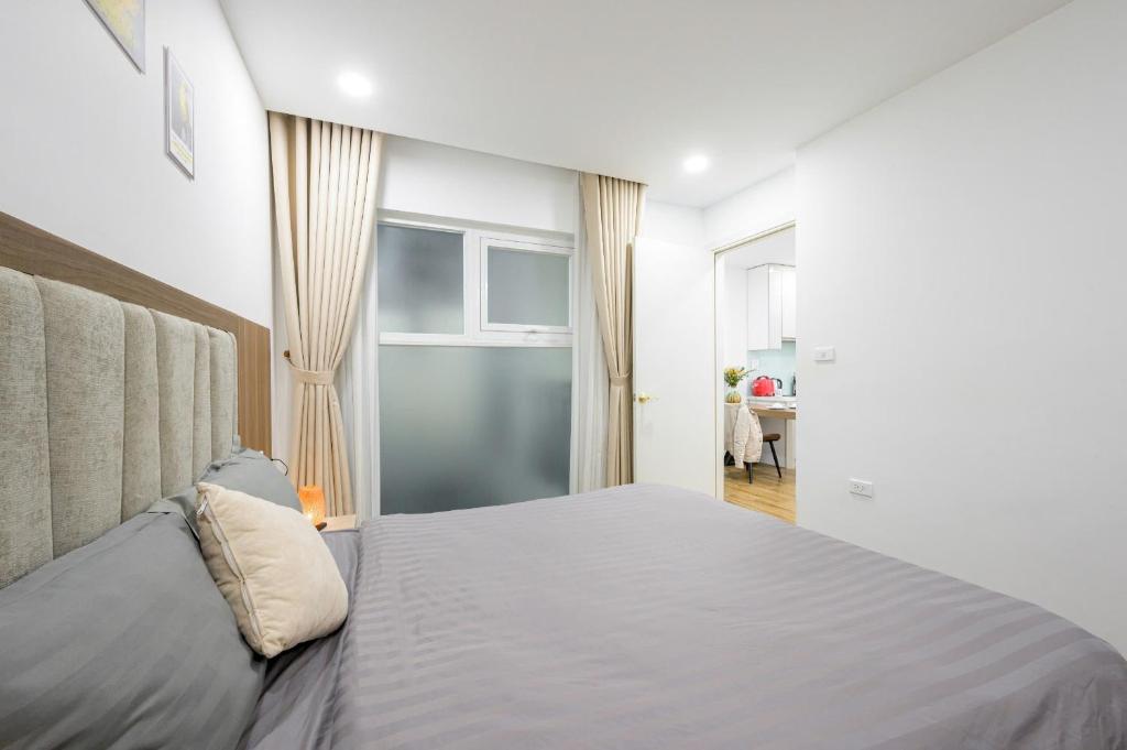 Postel nebo postele na pokoji v ubytování Luxe Paradise Hotel Nguyen Khac Hieu