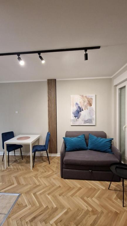 a living room with a couch and a table at King apartment in Novi Sad