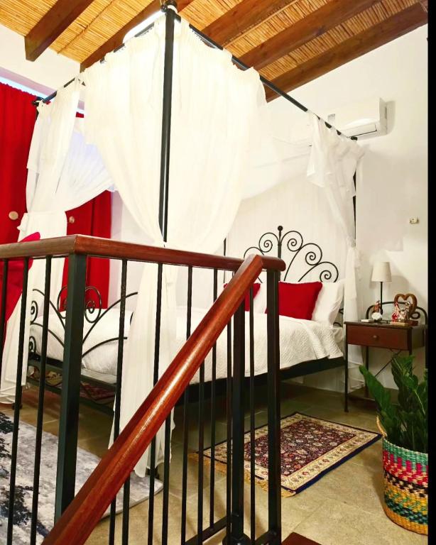 a bedroom with a bed with a canopy at Kozakos Luxury House in Pano Lefkara
