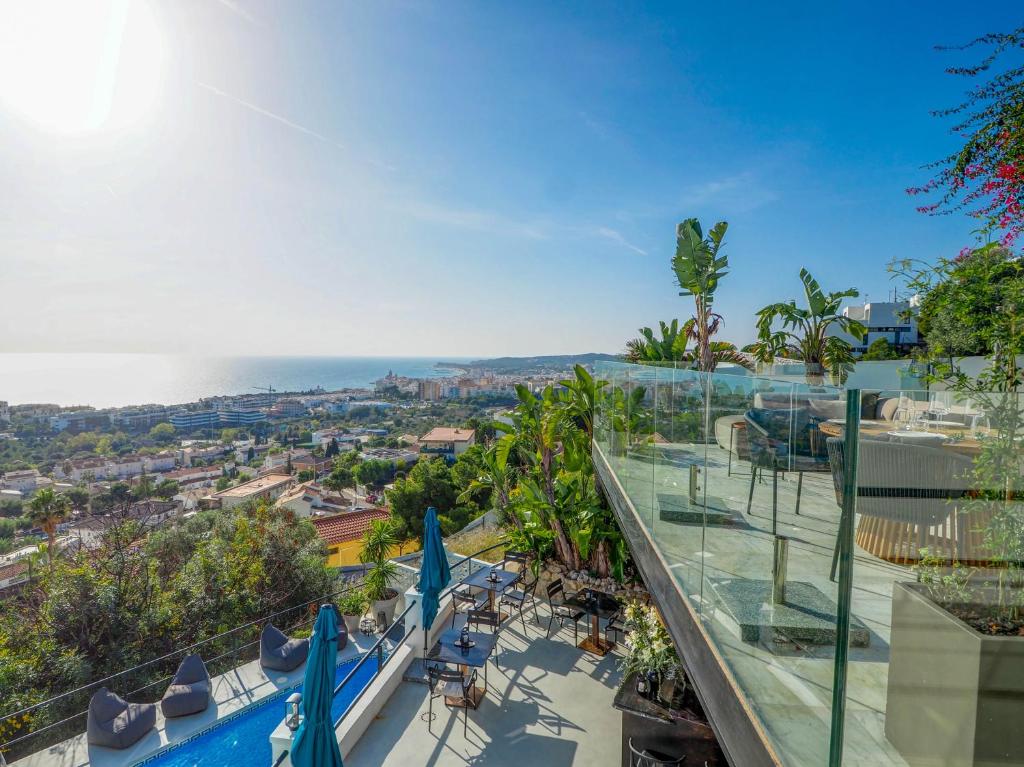 a view of the ocean from the balcony of a building at Bluehillsitges - Only Adults in Sitges