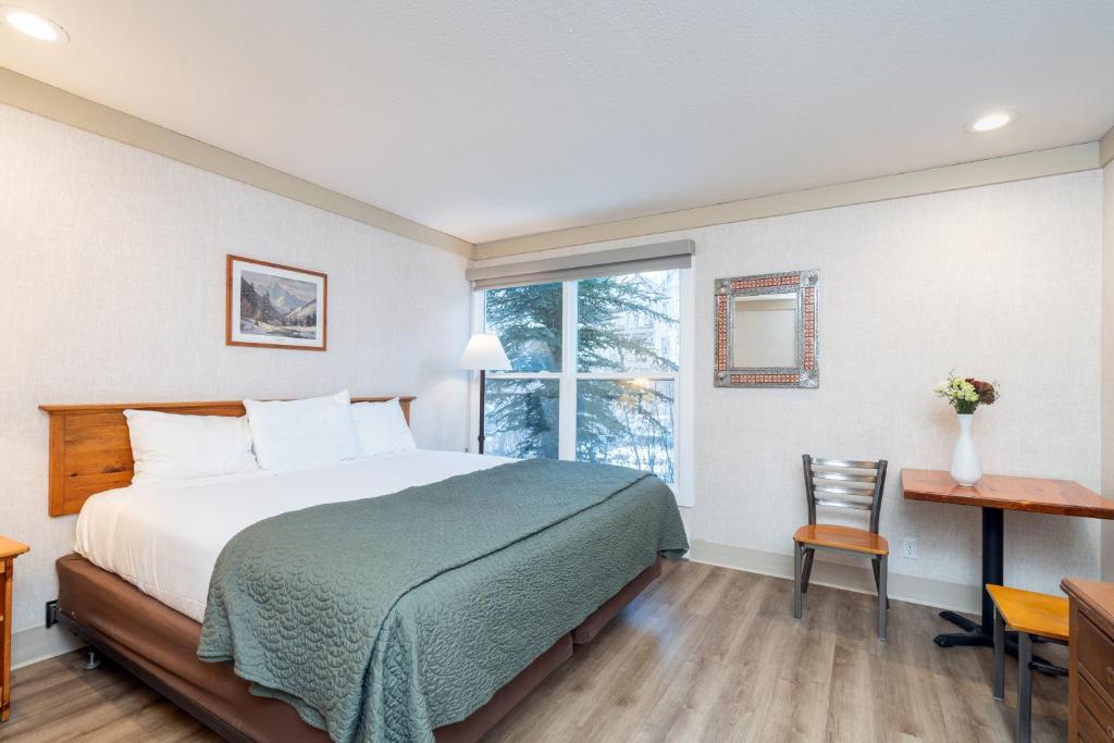 a hotel room with a bed and a window at Mountainside Inn 201 by Alpine Lodging Telluride in Telluride