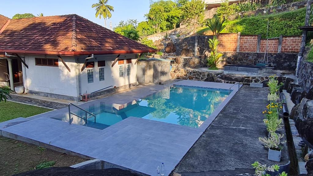a house with a swimming pool in the yard at GalleRetreat in Galle