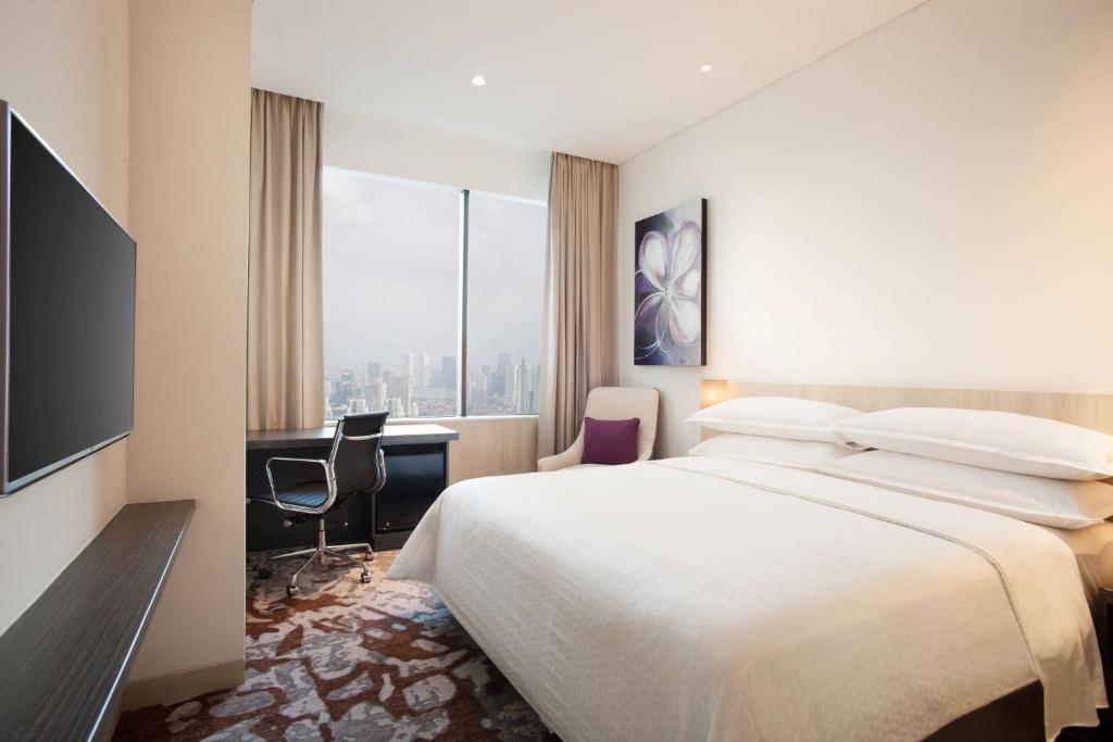 Postel nebo postele na pokoji v ubytování Four Points by Sheraton Jakarta Thamrin