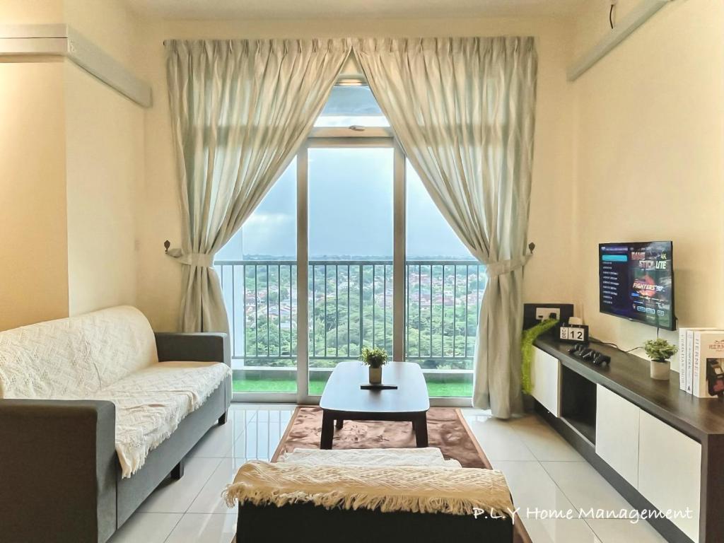 a living room with a couch and a large window at Ipoh Town CityView Premium Suite Kampung Paloh Residensi in Ipoh