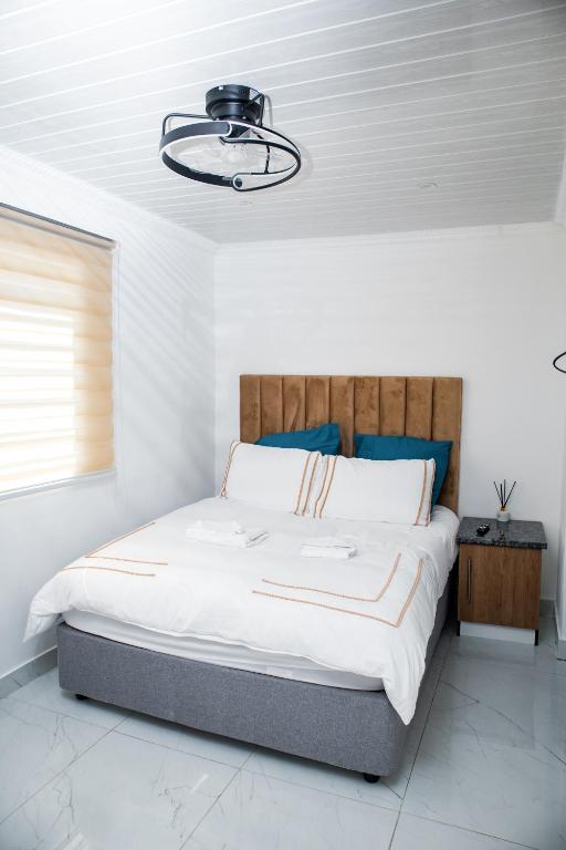a bedroom with a large bed with a wooden headboard at one bedroom apartment A1 in Cape Town