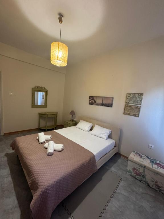 a bedroom with a large bed with towels on it at Peaceful house in Alexandroupoli
