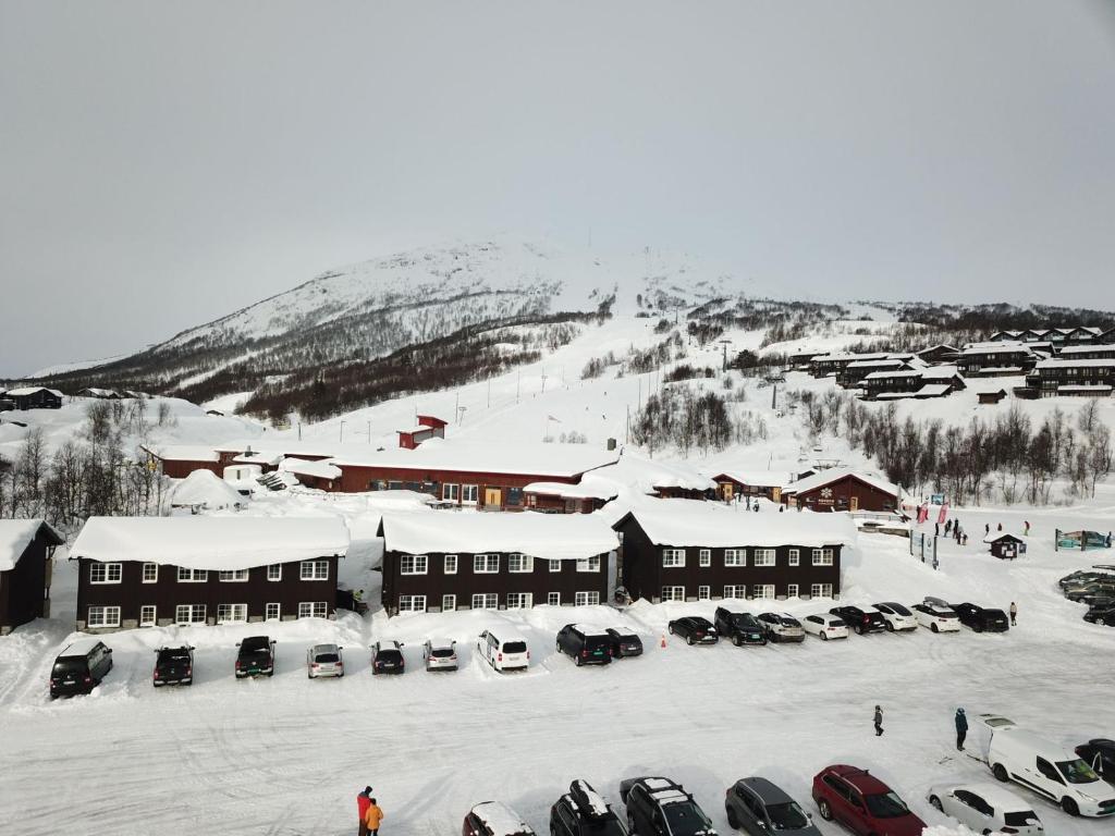 a snow covered parking lot in front of a ski resort at Lisletun in Hovden