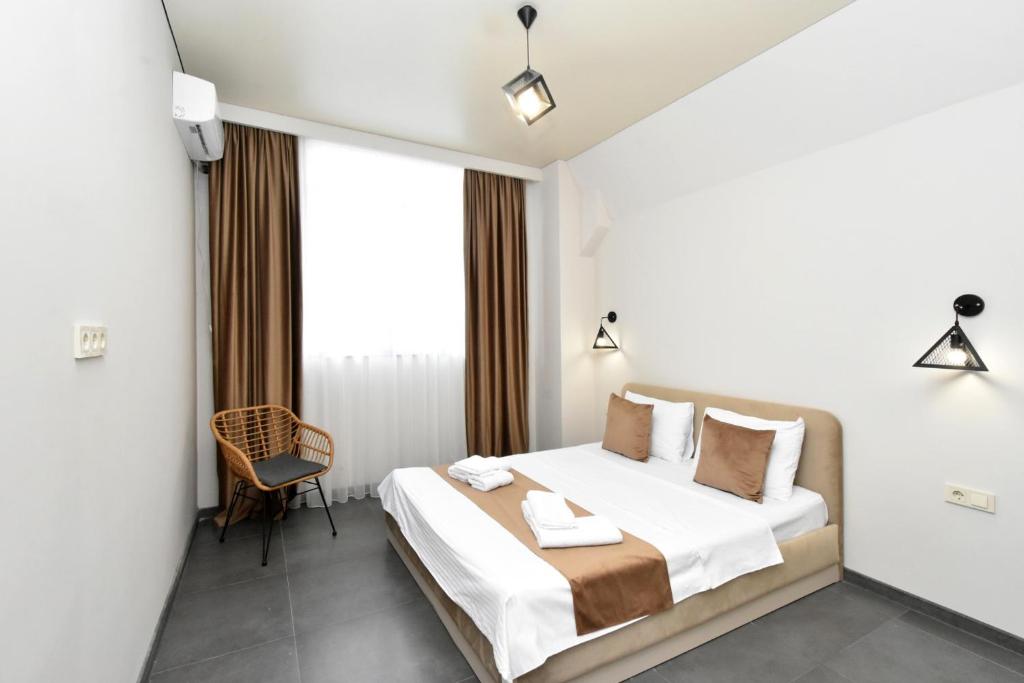 Postel nebo postele na pokoji v ubytování Seva Apart-Hotel Komitas