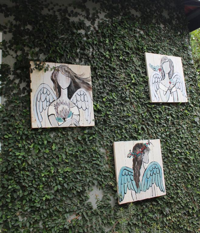 a group of drawings on the side of a wall at Angel Cottage in Tzaneen