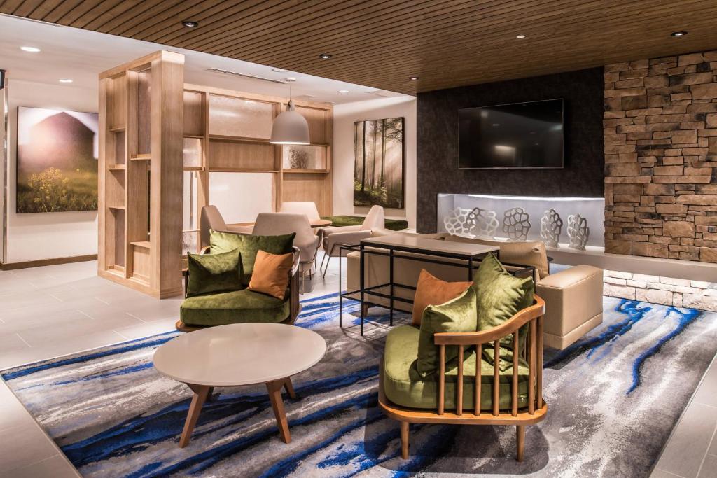 a living room with couches and a table at Fairfield Inn & Suites by Marriott Staunton in Staunton